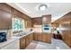Traditional kitchen with wood cabinets, white appliances, and a window over the sink at 4581 Newcastle Cir, Lithonia, GA 30038