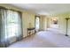 Bright living room with large windows, soft carpet, and neutral walls for versatile décor options at 4581 Newcastle Cir, Lithonia, GA 30038