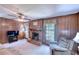 Cozy living room features wood paneling, a brick fireplace, and comfortable seating for relaxation at 4581 Newcastle Cir, Lithonia, GA 30038