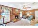 Cozy living room with a brick fireplace, wood paneling, and comfortable seating at 4581 Newcastle Cir, Lithonia, GA 30038