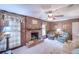 Comfortable living room showcasing a brick fireplace, wood paneling, and cozy seating arrangements at 4581 Newcastle Cir, Lithonia, GA 30038