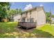 Spacious backyard with a wooden deck and well-maintained lawn, perfect for outdoor activities at 5867 Heritage Walk, Lithonia, GA 30058