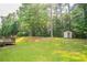 Expansive backyard with wooden deck, shed, and lush greenery for outdoor enjoyment at 5867 Heritage Walk, Lithonia, GA 30058