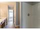 Bathroom area showcasing a shower, sink, access to other rooms, and wood-look flooring at 5867 Heritage Walk, Lithonia, GA 30058