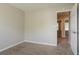 Comfortable bedroom with plush carpeting, open doorway, neutral paint, and white trim at 5867 Heritage Walk, Lithonia, GA 30058