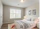 Cozy bedroom featuring soft carpeting, a comfortable bed, and tasteful decor at 5867 Heritage Walk, Lithonia, GA 30058