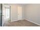 Bedroom with soft carpeting and an open doorway leading to other areas of the home at 5867 Heritage Walk, Lithonia, GA 30058