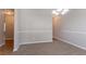 Cozy Dining Room with chair rail and chandelier. Neutral carpet and walls at 5867 Heritage Walk, Lithonia, GA 30058