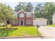 Traditional brick two-story home with a well-kept lawn and a convenient two-car garage at 5867 Heritage Walk, Lithonia, GA 30058
