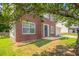 Charming brick front home with well-maintained lawn and mature tree in a suburban neighborhood at 5867 Heritage Walk, Lithonia, GA 30058