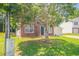 Charming brick front home with well-maintained lawn and mature tree in a suburban neighborhood at 5867 Heritage Walk, Lithonia, GA 30058