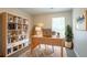 Functional home office with a built-in bookcase, natural light, and a comfortable workspace at 5867 Heritage Walk, Lithonia, GA 30058