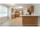 Charming kitchen with stainless steel appliances, wooden cabinets, tiled floor, and a breakfast bar at 5867 Heritage Walk, Lithonia, GA 30058