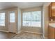 Bright breakfast nook featuring large windows and a tiled floor, adjacent to the kitchen area at 5867 Heritage Walk, Lithonia, GA 30058