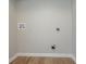 Laundry room showcasing hookups and wood-look floors for convenient laundry tasks at 5867 Heritage Walk, Lithonia, GA 30058