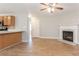Open floor plan featuring the living room fireplace, breakfast bar, and view into the kitchen at 5867 Heritage Walk, Lithonia, GA 30058