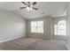 Spacious main bedroom features vaulted ceilings, plush carpeting, and refreshing natural light at 5867 Heritage Walk, Lithonia, GA 30058
