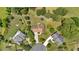 Expansive aerial view of a home showing mature trees, a large yard with a trampoline, and a circular driveway at 1002 Hallman Sw Ter, Marietta, GA 30064