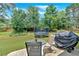 Relax on the patio in this backyard featuring manicured grass, a trampoline, and shade trees at 1002 Hallman Sw Ter, Marietta, GA 30064
