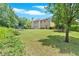 Large grassy backyard featuring mature trees and space to play in a serene suburban setting at 1002 Hallman Sw Ter, Marietta, GA 30064