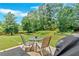 Enjoy this grassy backyard featuring a patio with an outdoor table and chairs, perfect for relaxing at 1002 Hallman Sw Ter, Marietta, GA 30064