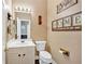 Cozy half bathroom features neutral walls, white vanity, and cute bear decor at 1002 Hallman Sw Ter, Marietta, GA 30064
