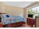 Bright bedroom with wood floors, large window, and colorful bedding at 1002 Hallman Sw Ter, Marietta, GA 30064