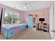 Bright bedroom with a ceiling fan, large window, and colorful decor at 1002 Hallman Sw Ter, Marietta, GA 30064