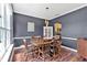 Formal dining room with elegant chandelier, dark wood flooring, and wainscoting detail at 1002 Hallman Sw Ter, Marietta, GA 30064