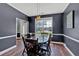 Traditional dining room features dark wood floors, gray walls with bright white trim, and modern chandelier at 1002 Hallman Sw Ter, Marietta, GA 30064