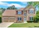 Attractive two-story home with stone accents, a well-kept lawn, and a two-car garage at 1002 Hallman Sw Ter, Marietta, GA 30064