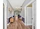Inviting hallway with hardwood floors, neutral paint, and decorative wainscoting at 1002 Hallman Sw Ter, Marietta, GA 30064