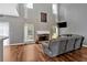 Bright living room with hardwood floors, tall windows, and a comfortable sectional sofa at 1002 Hallman Sw Ter, Marietta, GA 30064
