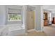 Inviting bathroom features a soaking tub, glass enclosed shower, and vanity with sink at 1002 Hallman Sw Ter, Marietta, GA 30064