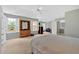 Large main bedroom offers a tray ceiling, multiple windows, and adjoins bonus room and bathroom at 1002 Hallman Sw Ter, Marietta, GA 30064
