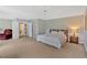 Spacious main bedroom with a tray ceiling, neutral walls and carpet, and multiple entry doors at 1002 Hallman Sw Ter, Marietta, GA 30064