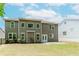 Spacious backyard featuring a well-maintained lawn, concrete patio, and views of the home's exterior at 2023 Jameson Cir, Lawrenceville, GA 30043