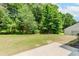Spacious backyard featuring a lush lawn and green trees at 2023 Jameson Cir, Lawrenceville, GA 30043