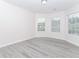 Bright bedroom featuring multiple windows letting in natural light and hardwood flooring at 2023 Jameson Cir, Lawrenceville, GA 30043