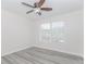 Bedroom featuring a ceiling fan, window, and hardwood floors at 2023 Jameson Cir, Lawrenceville, GA 30043