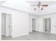 A bedroom featuring gray wood flooring, a ceiling fan, and 3 closets at 2023 Jameson Cir, Lawrenceville, GA 30043