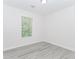 Bedroom with a window letting in natural light and hardwood flooring at 2023 Jameson Cir, Lawrenceville, GA 30043