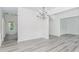 A dining room featuring gray wood flooring, crown moulding, and a chandelier at 2023 Jameson Cir, Lawrenceville, GA 30043