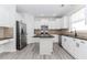 Bright kitchen featuring white cabinetry, stainless steel appliances, granite countertops, and a center island at 2023 Jameson Cir, Lawrenceville, GA 30043