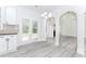 Eat-in kitchen featuring white cabinets, stainless steel appliances, granite counters and view into the living room at 2023 Jameson Cir, Lawrenceville, GA 30043