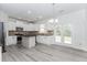 Well-lit kitchen with white cabinets, stainless steel appliances, granite countertops, and access to the backyard at 2023 Jameson Cir, Lawrenceville, GA 30043