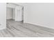 Living room featuring grey wood flooring, crown moulding, and recessed lighting at 2023 Jameson Cir, Lawrenceville, GA 30043