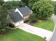 Aerial view of the home featuring a long driveway, two-car garage, and well-maintained landscaping at 2031 Greyfield Nw Dr, Kennesaw, GA 30152