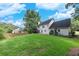 Expansive backyard features a lush green lawn, mature trees, and a well-maintained lawn at 2031 Greyfield Nw Dr, Kennesaw, GA 30152
