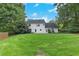 Expansive backyard offers a lush green lawn, mature trees, and privacy at 2031 Greyfield Nw Dr, Kennesaw, GA 30152